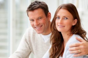 Portrait of smiling young couple working on laptop together